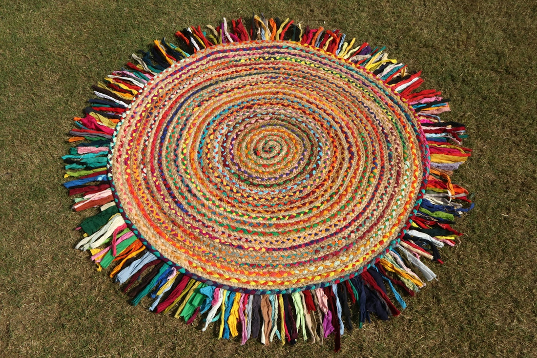 A colorful, circular rug with a fringe