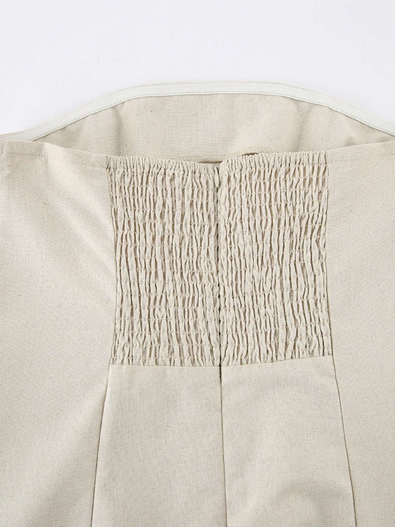 Close-up of the elasticized smocked back on the Smocked Back Hemp & Cotton Tube Dress highlighting the stretchy texture.