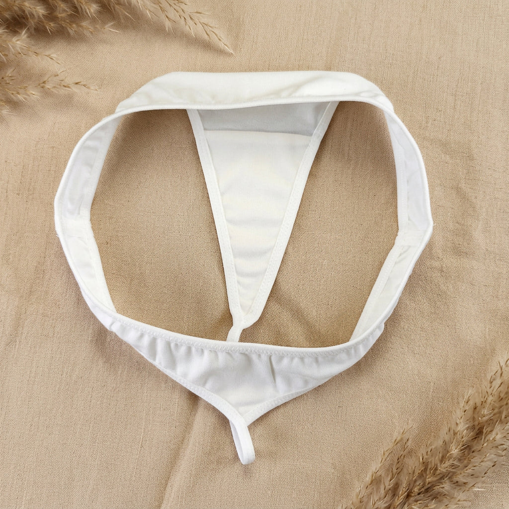 White underwear bottom laid flat on a dark gray fabric background.