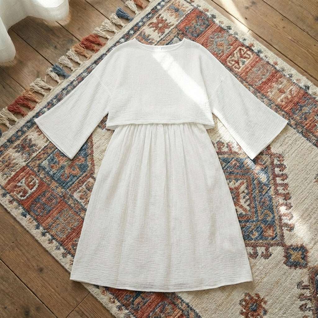 Women’s two-piece lounge set in soft pure cotton, featuring an oversized long-sleeve button-down shirt and matching wide-leg trousers in [Insert Color].