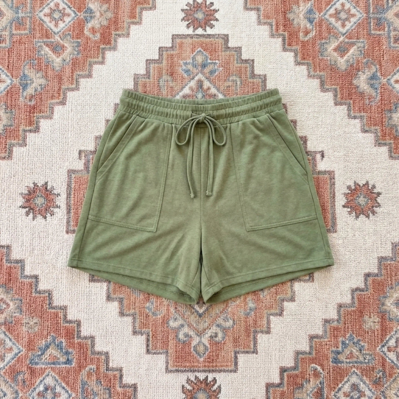 Green shorts on a patterned rug