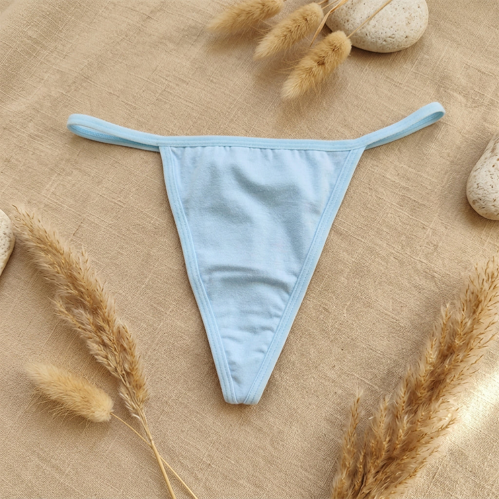 A light blue g-string thong laid flat on a brown textured fabric background.