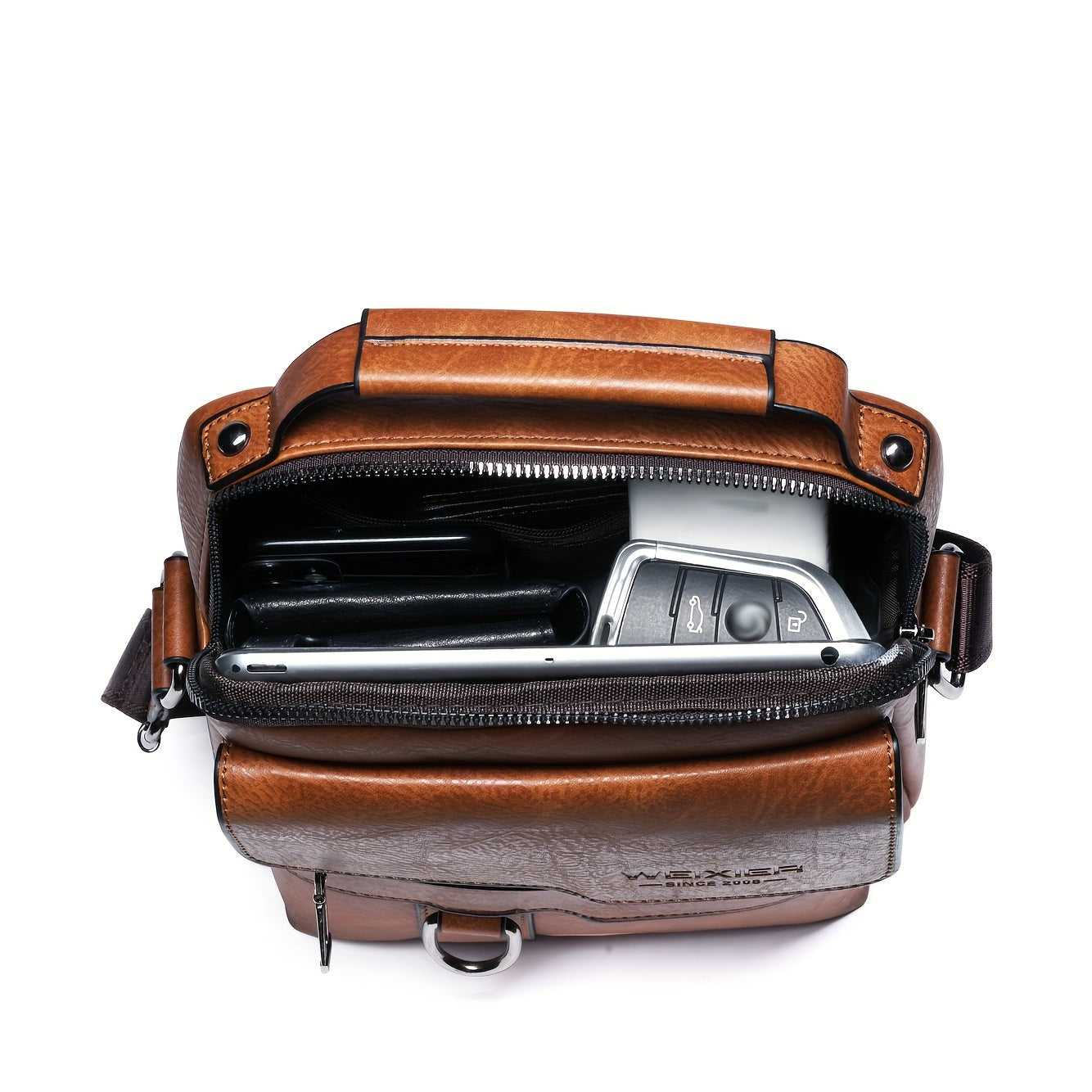 Brown leather bag with a camera inside on a white background